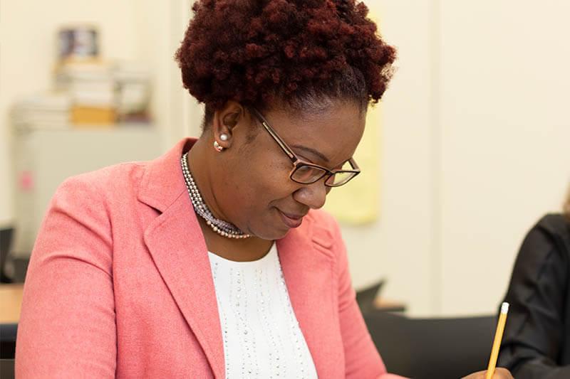 Woman writing in class